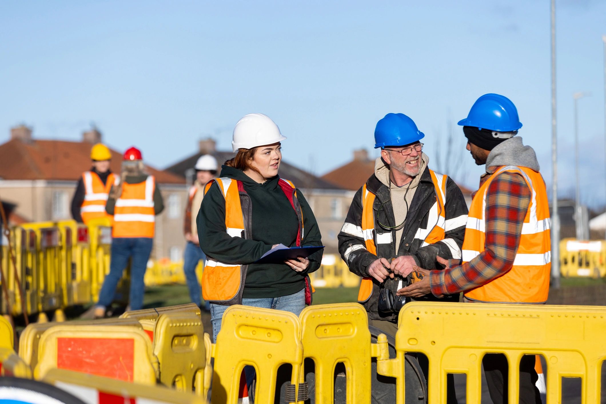 Engineers and builders reviewing work plans on site